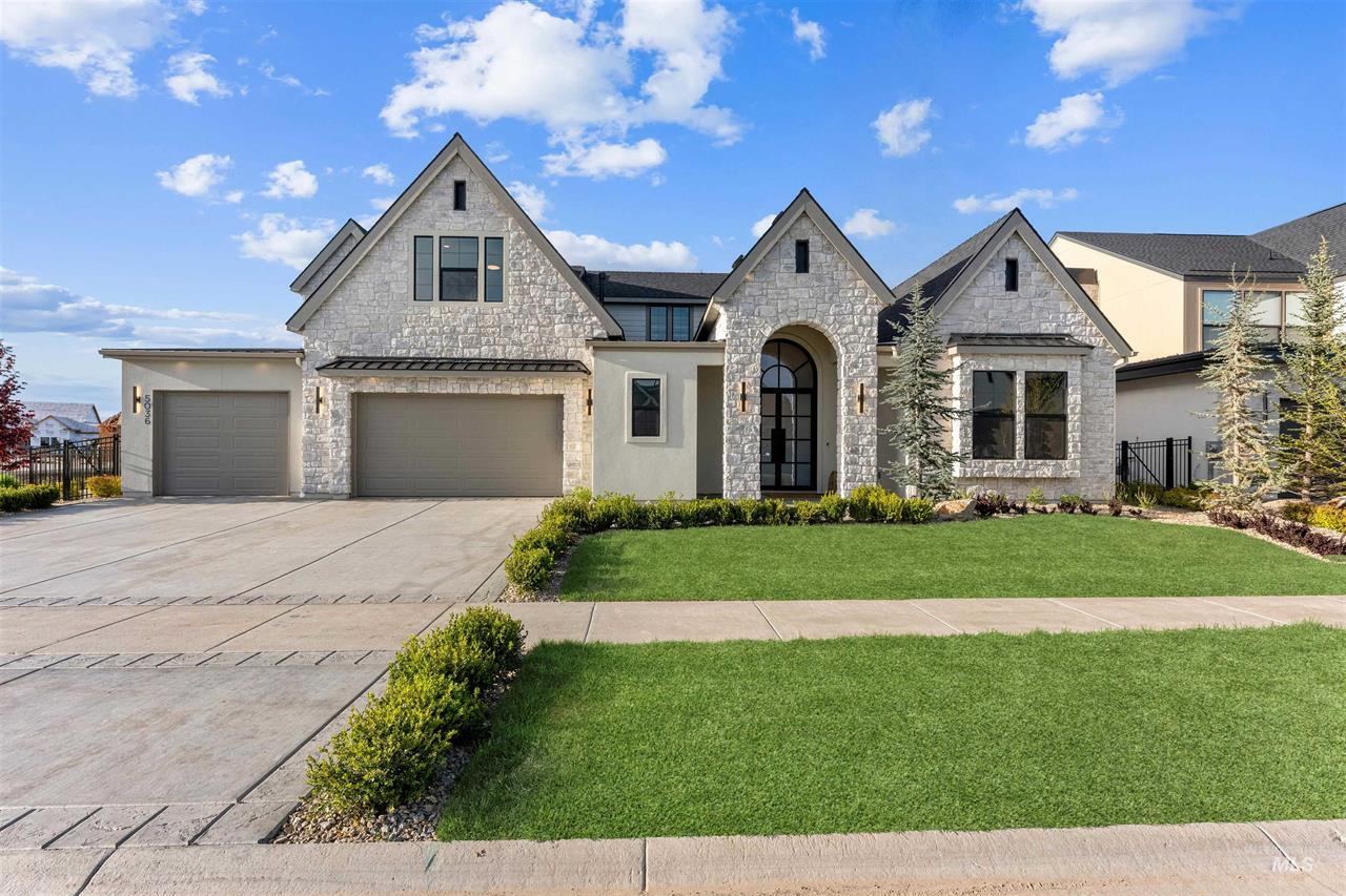 Front of a stone and stucco home with a three-car garage
