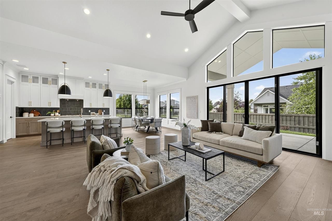 Open great room and kitchen with tall windows