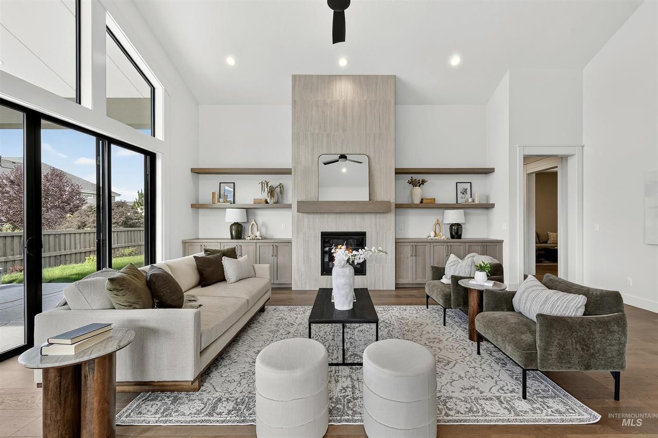 Bright living room with a tiled fireplace and built-in shelves